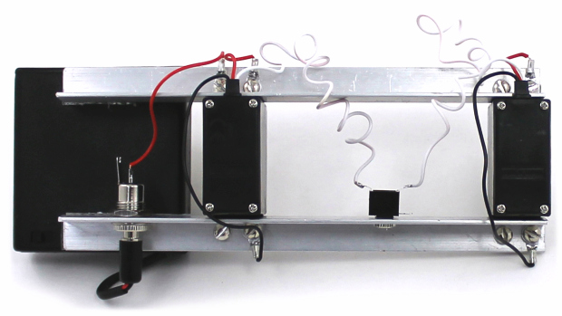 The lower rail is grounded through the power jack case contact and provides a common ground connection for the TRS jack and servos.  The upper rail is held at Vcc through the power jack center pin jumper wire, and carries drive current to both servos.