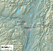 A relief map shows Albany on a flat plain near two rivers, surrounded by mountainous regions.
