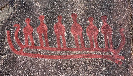 Six men in a boat of the same model as the Hjortspring boat, a detail of Cobbler's Cliff (Skomakarhällen) in Backa Petroglyph Area (or Backa Rock Carvings) Brastad, Lysekil Municipality, Sweden